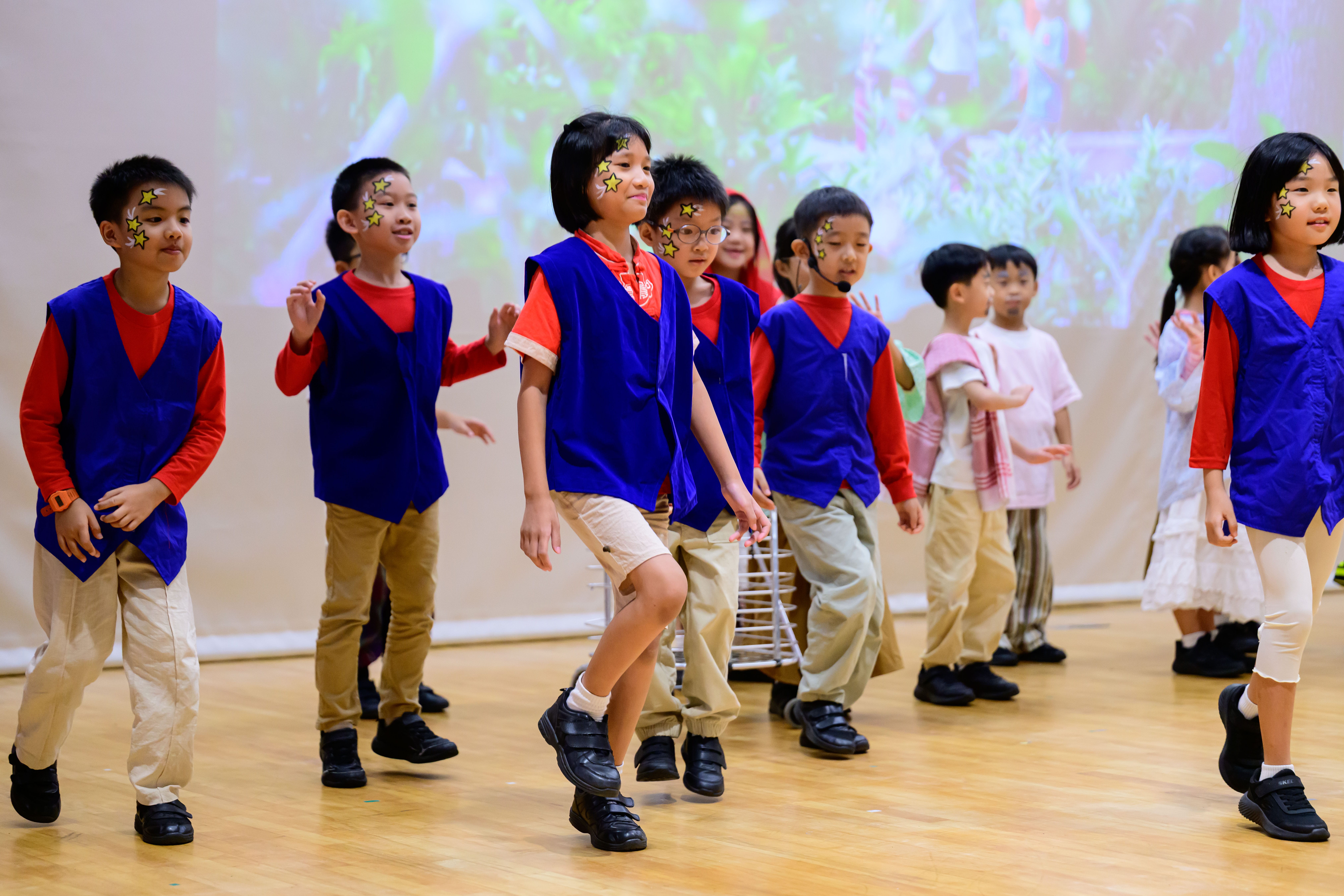 Primary 2 pupils performing on stage.